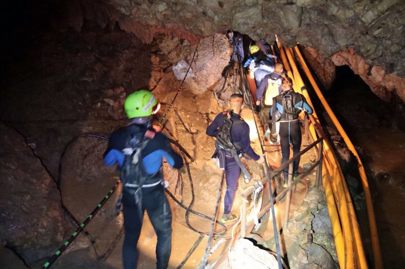 In this undated photo released by Royal Thai Navy, Thai rescue team members walk inside a cave where 12 boys and their soccer coach have been trapped since June 23, in Mae Sai, Chiang Rai province, northern Thailand on on Saturday, July 7, 2018. Photo: AP