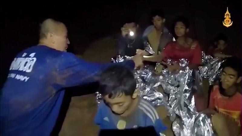 Boys from the under-16 soccer team trapped inside Tham Luang cave receive treatment from a medic in Chiang Rai, Thailand, in this still image taken from a July 3, 2018 video by Thai Navy Seal. Photo: Thai Navy Seal via Reuters