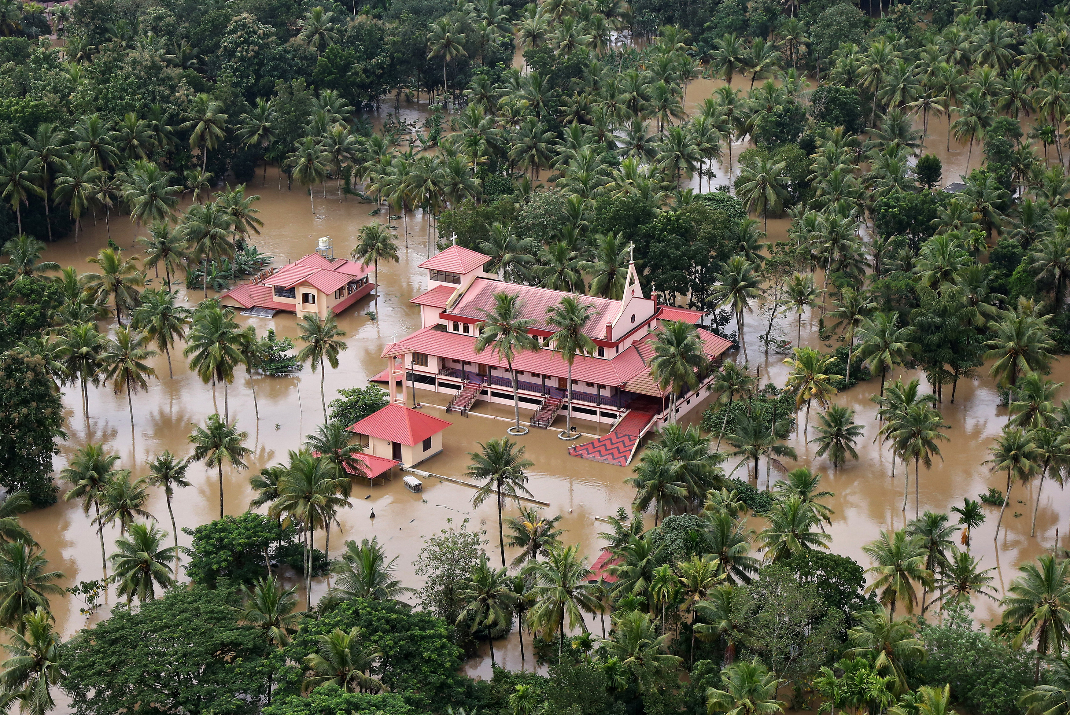 An aerial view shows partially submerged houses at a flooded area in the southern state of Kerala, India, August 17, 2018. REUTERS