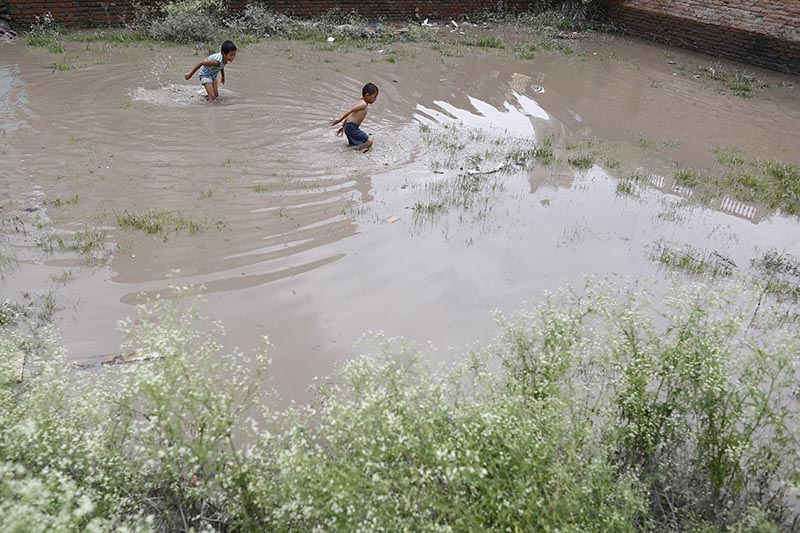 Children playing in floodwater in Anamnagar, Kathmandu, on Wednesday, August 15, 2018. Photo: Skanda Gautam/ THT
