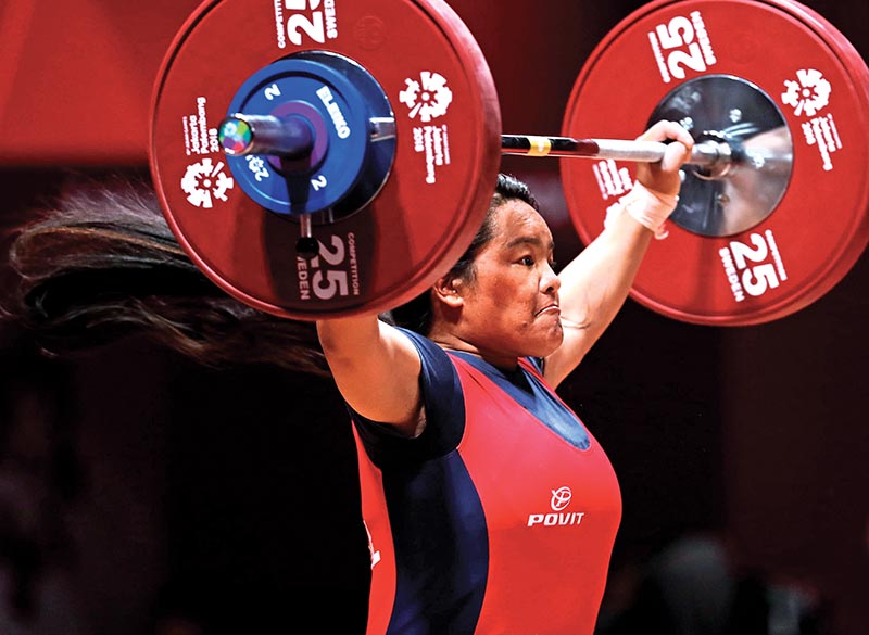 Tara Devi Pun of Nepal lifts weight during the womenu2019s 75kg weight category event.