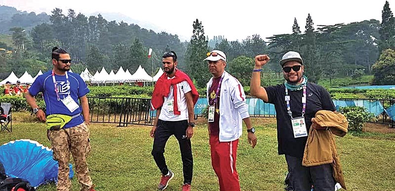 Nepali paragliding team members react after the fourth round of the Cross Country event.