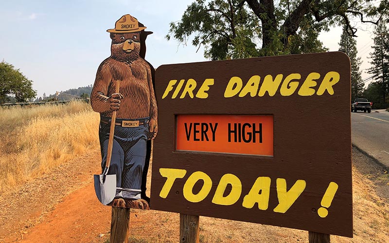 A sign by the side of the road warns of the threat of wildfires which have been fueled by continued hot weather outside the town of Colfax, California, US, on August 4, 2018.  Photo: Reuters