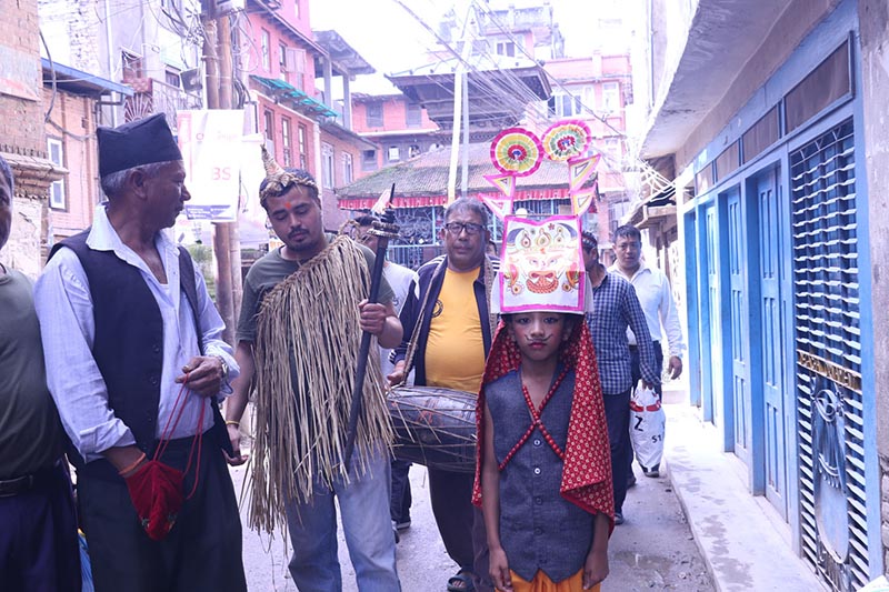 A boy dressed in festival costume marching with his relatives in a procession to mark Gaijatra festival, in Madhyapur Thimi, Bhaktapur, on Monday, August 27, 2018. Photo: RSS