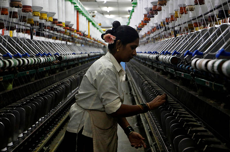 A woman works at a textile mill in Mumbai, India March 8, 2018. Photo: Reuters