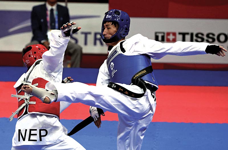 Nepalu2019s taekwondo player Gyanendra Hamal (left) fights against Bhutanu2019s Jigme Wangchuk during the menu2019s 68kg event of the 18th Asian Games in Jakarta, Indonesia on Thursday. Photo: AP