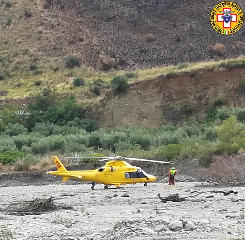 A rescue helicopter is seen after several people were killed in a mountain gorge flooding, in the municipality of Civita, Calabria, Italy August 20, 2018 in this image obtained from social media. Corpo Nazionale Soccorso Alpino e Speleologico/via Reuters