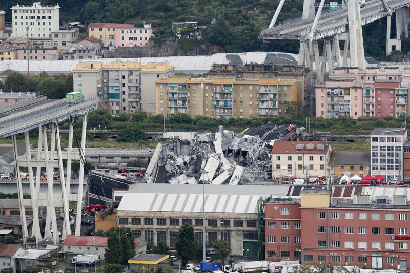 Cars are blocked on the Morandi highway bridge after a section of it collapsed, in Genoa, northern Italy, on Tuesday, Aug. 14, 2018.