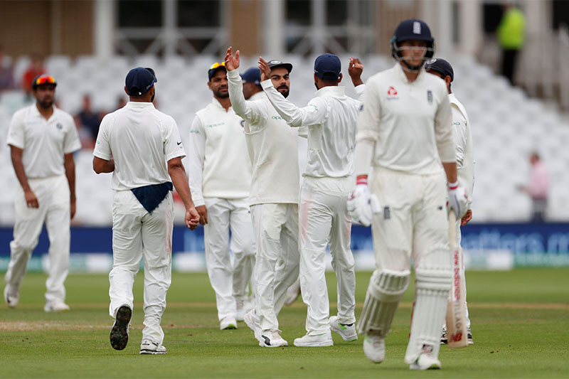 India players celebrate taking the wicket of England's Joe Root. Photo: Reuters
