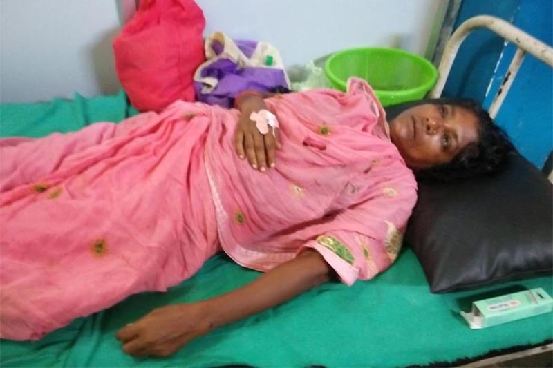 Laxmi Kumari Mahato, 48, a victim of severe beating, receiving treatment in a private clinic, in Siraha, on Wednesday, August 22, 2018. Photo: THT