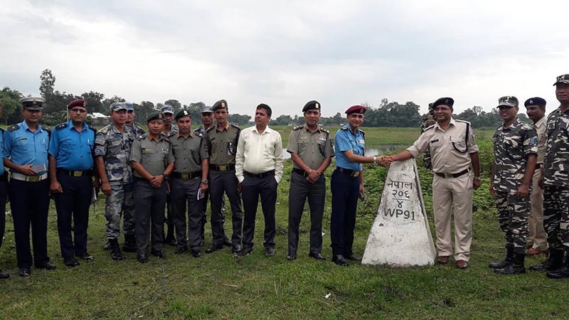 Security personnel from Nepal and India posing for a photo after agreeing to work together to curb criminal nactivities in border areas, in Bhantabari, Sunsari, on Monday, August 20, 218. Photo: THT