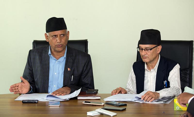 Gandaki Province Minister for Communication Ram Saran Basnet (left)  reading out the decision of the Council of Ministers, in Pokhara, on Wednesday, August 1, 2018. Photo: THT