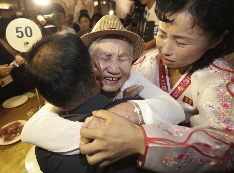 South Korean Lee Keum-seom, 92, center, hugs her North Korean son Ri Sang Chol, 71, left, with Kim Ok Hui, daughter-in-law of Ri Sang Chol during the Separated Family Reunion Meeting at the Diamond Mountain resort in North Korea, on Monday, Aug. 20, 2018. Photo: AP