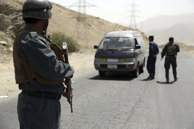 Afghan police officers search a vehicle at a checkpoint on the Ghazni highway, in Maidan Shar, west of Kabul, Afghanistan on Monday, Aug. 13, 2018. Photo: AP