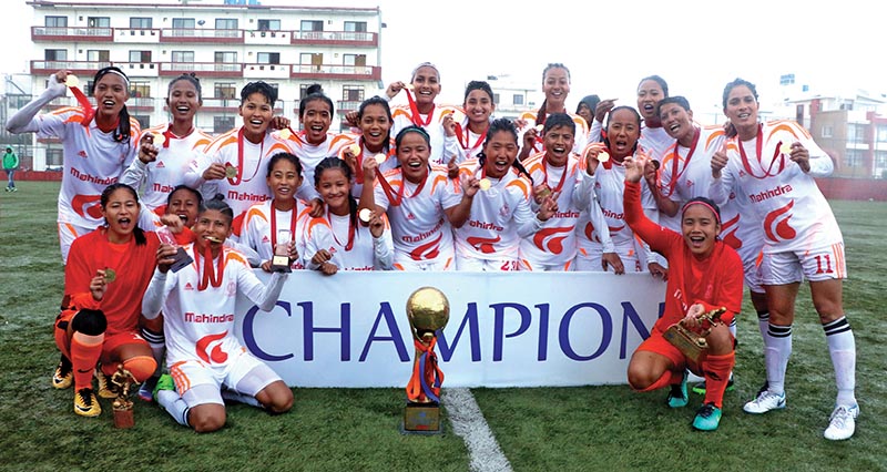 Nepal APF Club team members celebrate with the trophy after winning the Vice-president Women's National Football League at the ANFA Complex grounds in Lalitpur on TUesday. Photo: THT