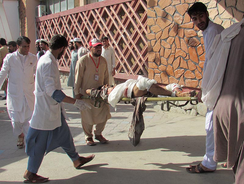 Afghan men carry an injured man to a hospital after a suicide attack in Nangarhar province, Afghanistan September 11, 2018. Photo: Reuters