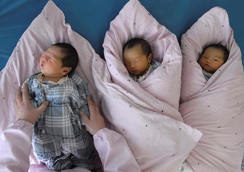 A nurse takes care of new-born infants at a hospital in Huai'an, Jiangsu province, China,  March 3, 2008. Photo: Reuters/ File