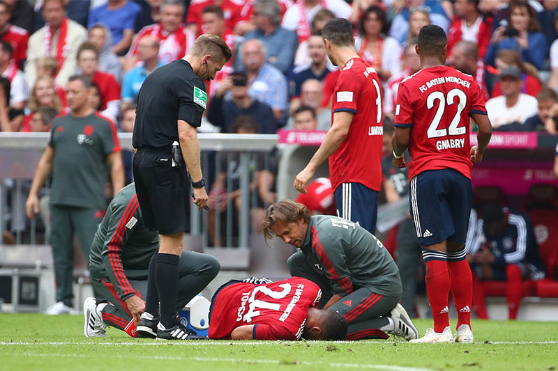 Bayern Munich's Corentin Tolisso receives medical attention after sustaining an injury. Photo: Reuters