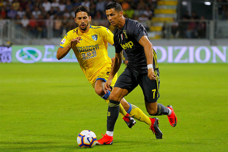 Juventus' Cristiano Ronaldo in action with Frosinone's Edoardo Goldaniga. Photo: Reuters