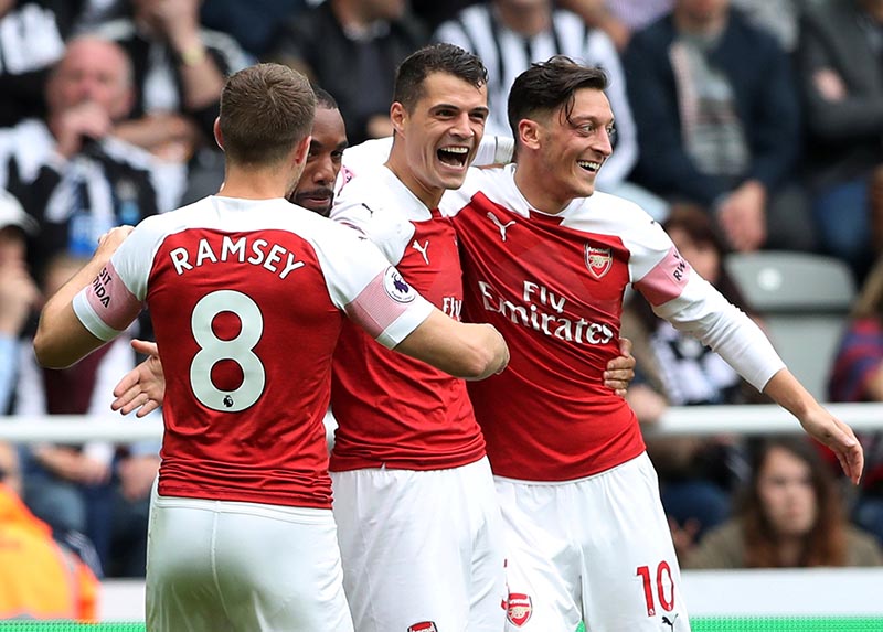 Arsenal's Granit Xhaka celebrates scoring their first goal with Aaron Ramsey, Alexandre Lacazette  and Mesut Ozil during the Premier League match between  Newcastle United and Arsenal, at St James' Park, in Newcastle, Britain, on September 15, 2018. Photo: Reuters