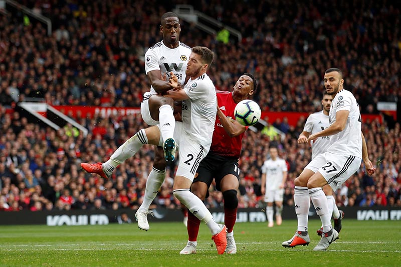 Manchester United's Anthony Martial in action with Wolverhampton Wanderers' Matt Doherty and Willy Boly during the Premier League match between Manchester United and Wolverhampton Wanderers, at Old Trafford, in Manchester, Britain, on September 22, 2018. Photo: Action Images via Reuters