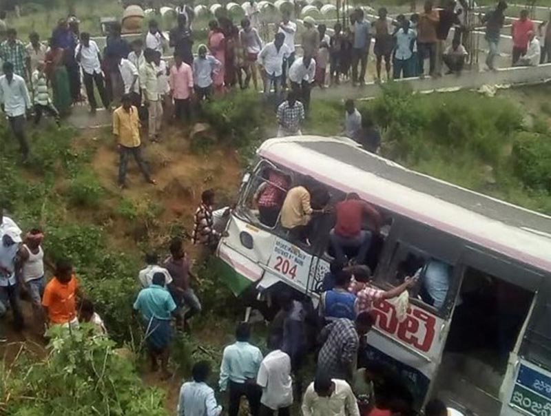Onlookers and rescuers gather around a bus that crashed in Jagtial district in India's southern Telangana state on Tuesday, September 11, 2018. A bus carrying pilgrims from a temple in southern India veered off the road and plunged onto a valley killing 43 people, an official said. Photo: AFP