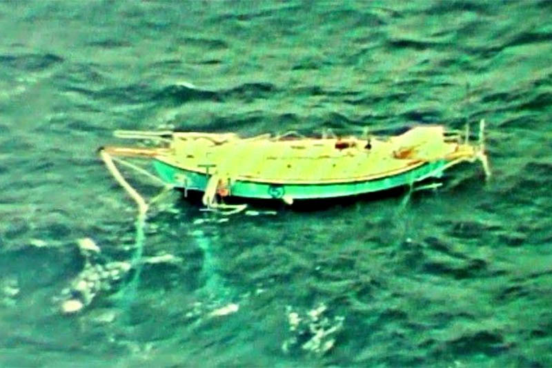 The capsized yacht Thuriya of solo sailor Abhilash Tomy is pictured at sea in this September 24, 2018 handout photo by the Indian Navy. Photo: Reuters