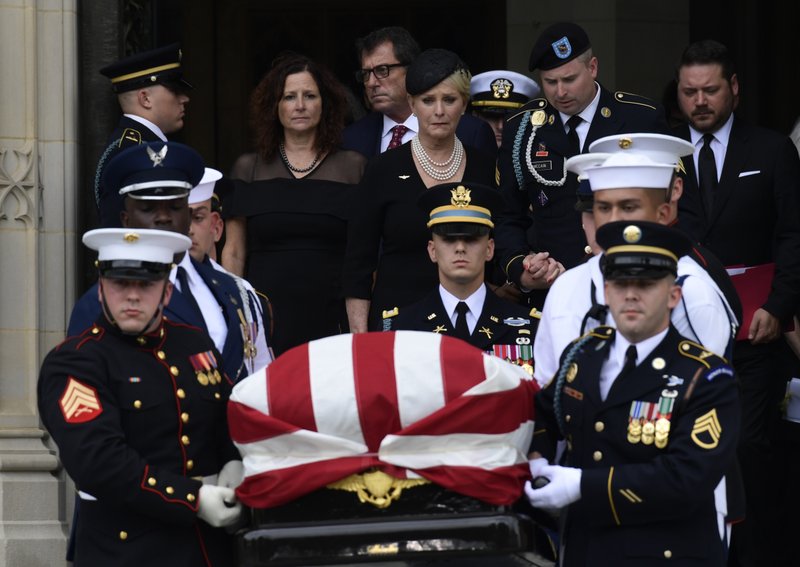 The casket of Sen. John McCain, R-Ariz., is carried out of the Washington National Cathedral in Washington, Saturday, Sept. 1, 2018, after a memorial service, as Cindy McCain is escorted by her son Jimmy McCain and other family members. Photo: APn