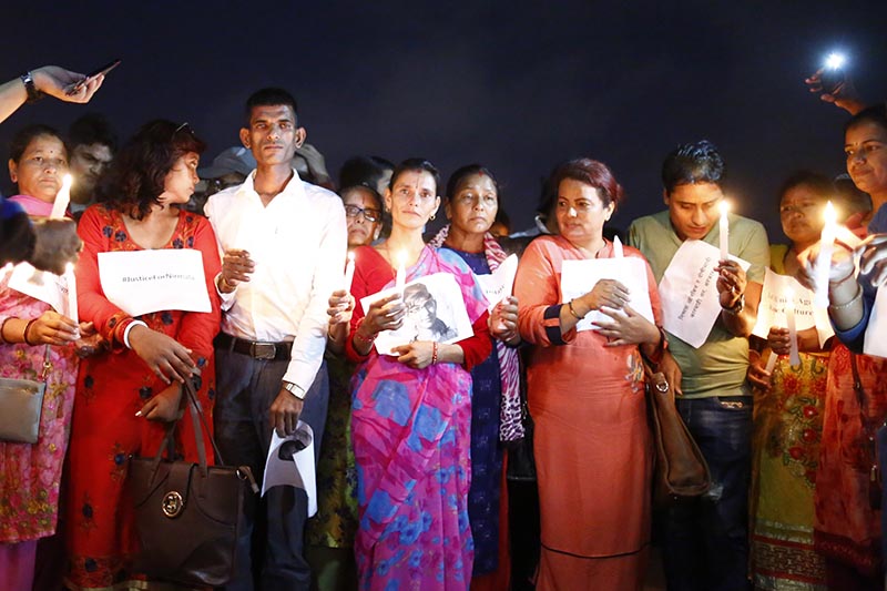 The parents of 13-year-old Nirmala Panta, who was raped and murdered in Kanchanpur district 50 days ago, along with their supporters from Kanchanpur, holding a candle light vigil for Nirmala, in Kathmandu, on Thursday, September 13, 2018. Photo: Skanda Gautam/THT