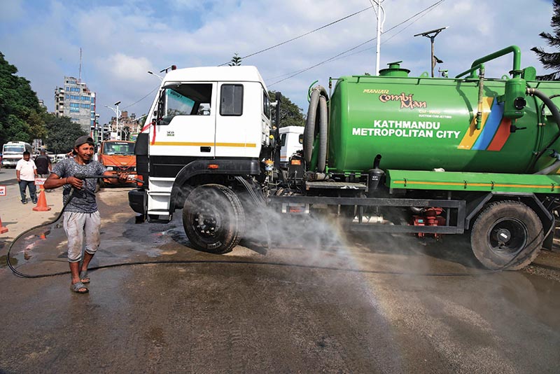 A worker cleaning a road using jet machine, in Kathmandu, on Saturday. Photo: THT