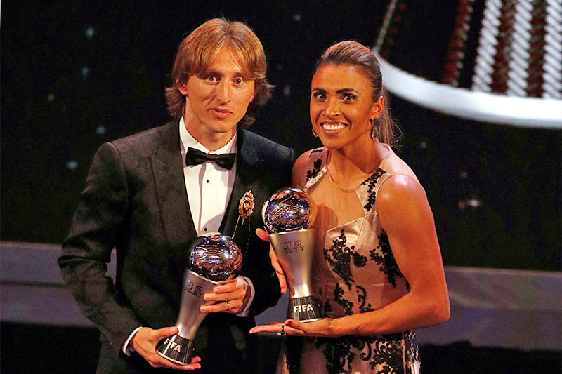 Luka Modric and Marta pose with their awards. Photo: Reuters