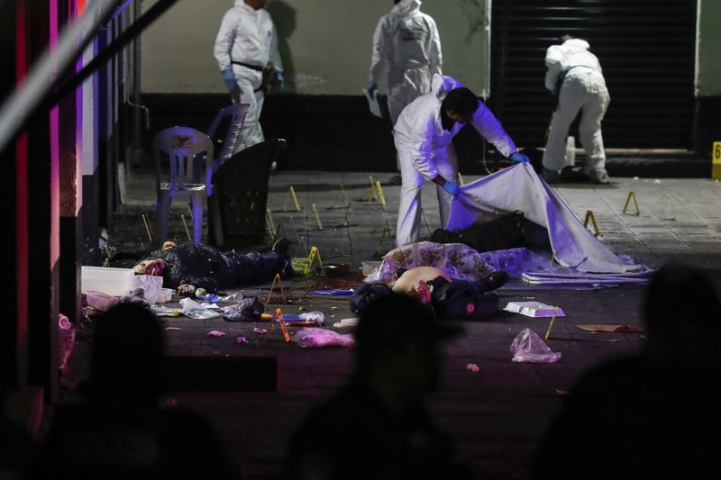 A crime scene worker covers up one of the bodies of victims of a shooting in Garibaldi Plaza, in Mexico City, on Friday Sept. 14, 2018. Photo: AP