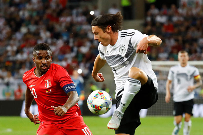 Germany's Nico Schulz in action with Peru's Jefferson Farfan. Photo: Reuters