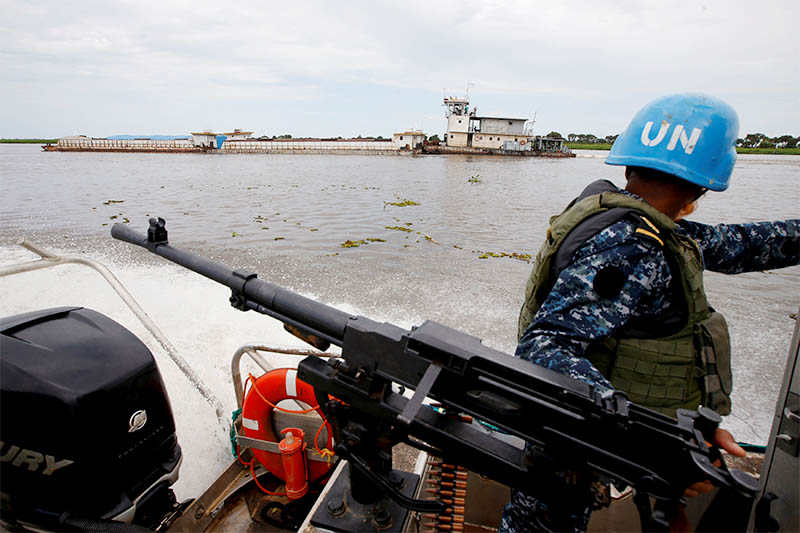 A Bangladeshi Navy peacekeeper from UNMISS (UN Mission in South Sudan) looks at a World Food Program barge while patrolling on the white Nile near the town of Malakal, in the Upper Nile state of South Sudan, September 8, 2018. Photo: Reuters