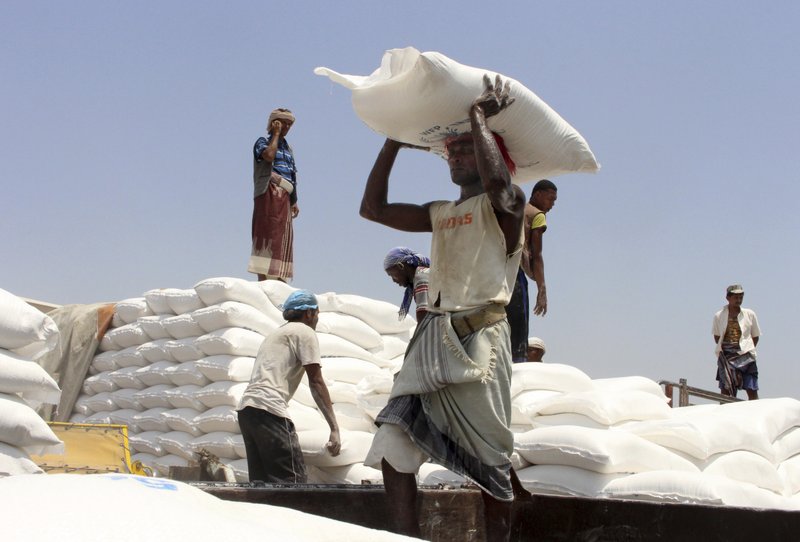 In this photo, men deliver UN World Food Programme (WFP) aid in Aslam, Hajjah, Yemen on Sept. 21, 2018. Photo: AP