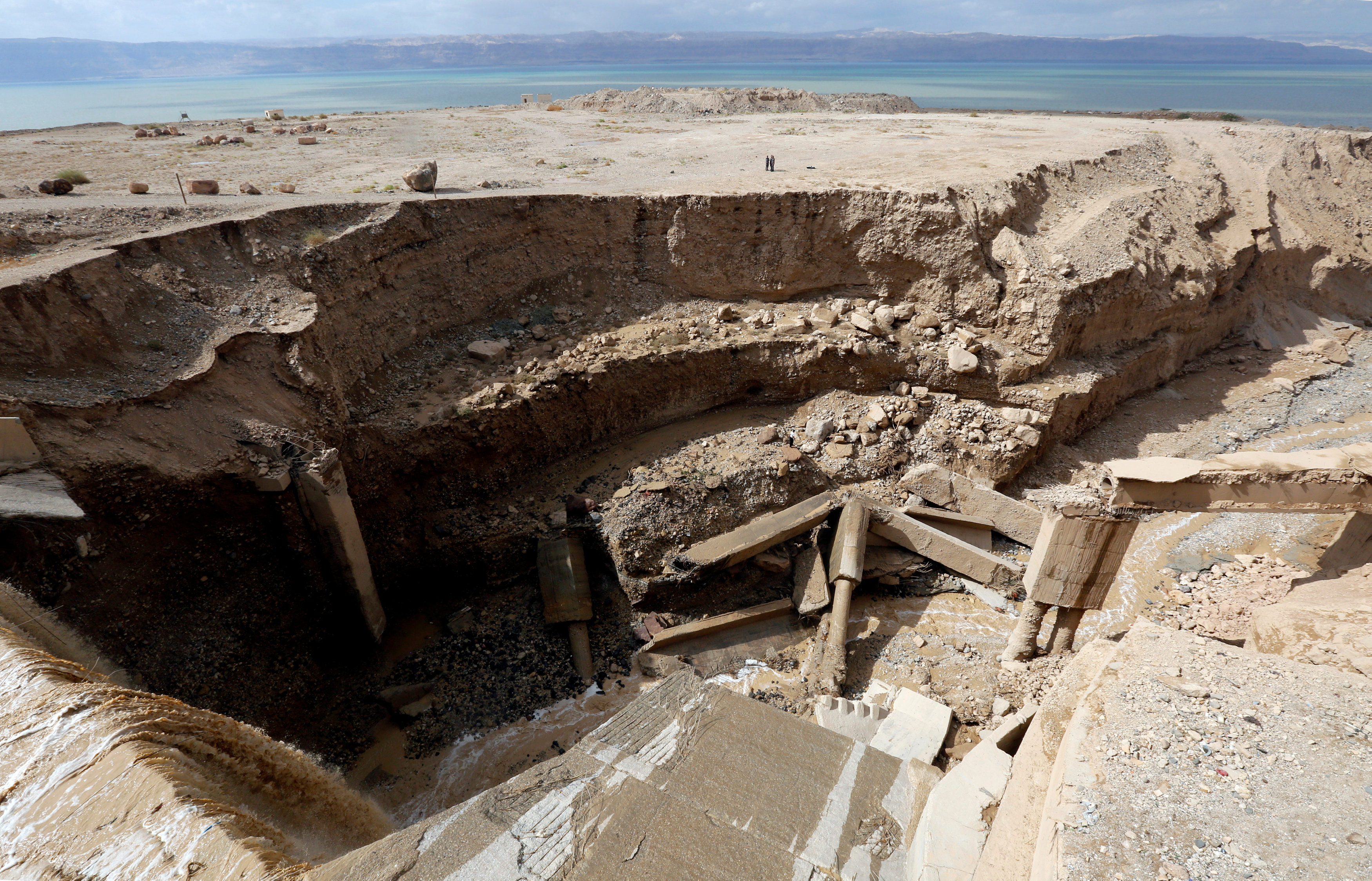 Civil defense members look for survivors after rain storms unleashed flash floods, near the Dead Sea, Jordan October 26, 2018. REUTERS