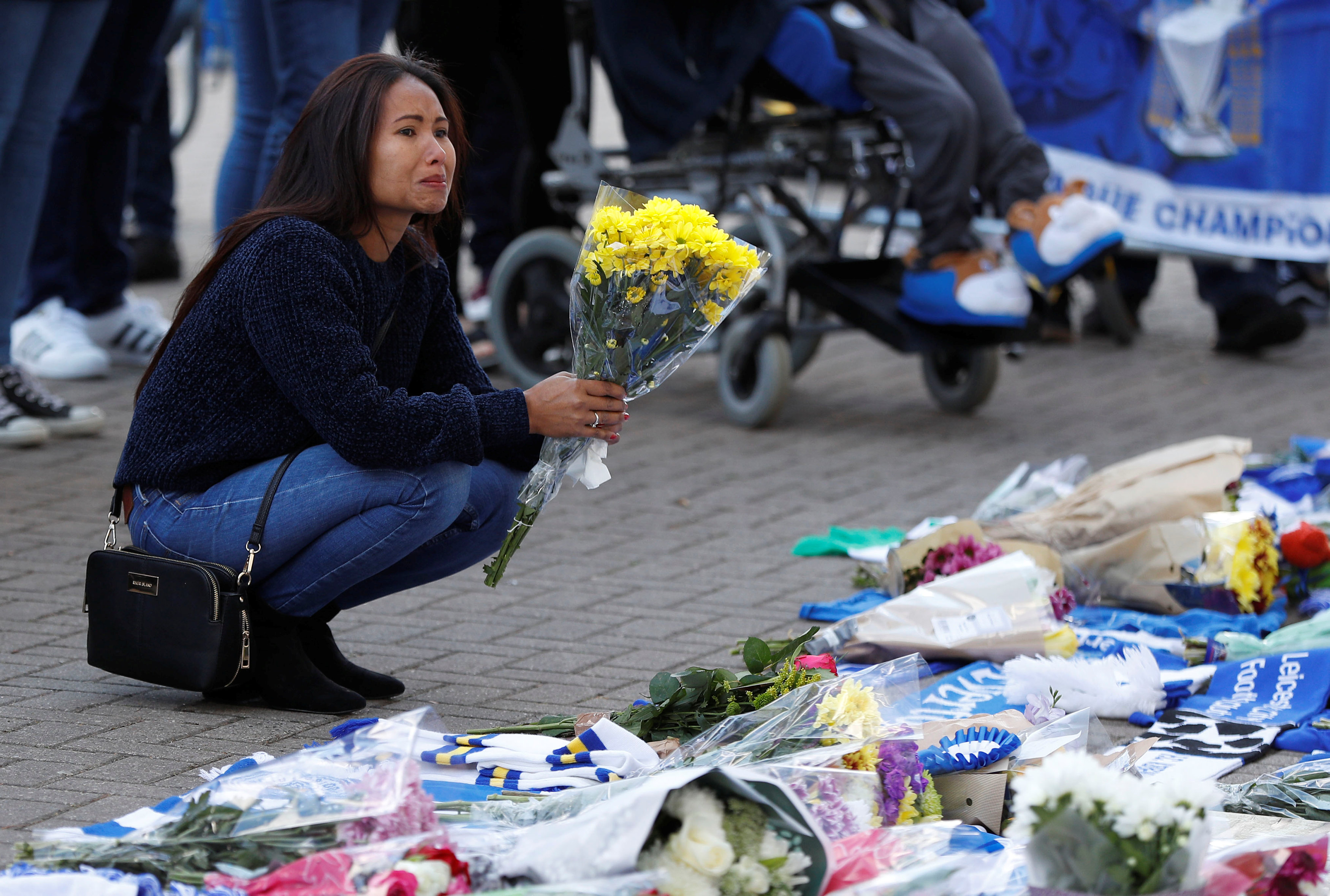 Leicester City football fans pay their respects outside the football stadium, after the helicopter of the club owner Thai businessman Vichai Srivaddhanaprabha crashed when leaving the ground on Saturday evening after the match, in Leicester, Britain, October 28, 2018. REUTERS