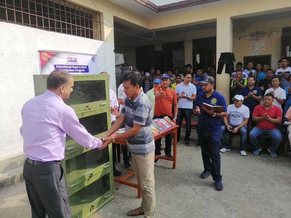 Chief of Rotary Club of Narayangadh hands over books and a steel cabinet to the Assistant Prison Chief at Dhading Prison. Photo: Keshav Adhikari/THT