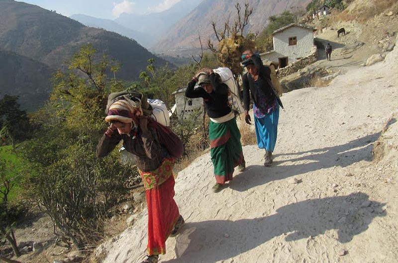 Women returning home with rice bought from the local market, in Himali Rural Municipality, Bajura, on Thursday, October 25, 2018. Photo: THT