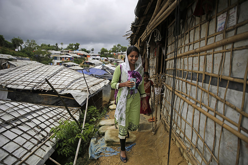 In this Aug 27, 2018 photo, Rahima Akter walks through Balukhali refugee camp in Bangladesh. Rahima is a 19-year-old refugee who dreams of becoming the most educated Rohingya woman in the world. She recently finished high school and hopes to study human rights in college. Photo: AP