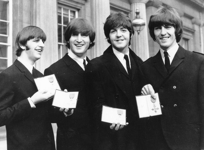 FILE - In this photo The Beatles, from left: Ringo Starr, John Lennon, Paul McCartney and George Harrison smile as they display the Member of The Order of The British Empire medals presented to them by Queen Elizabeth II in a ceremony in Buckingham Palace in London, England on Oct. 26, 1965. Photo: AP