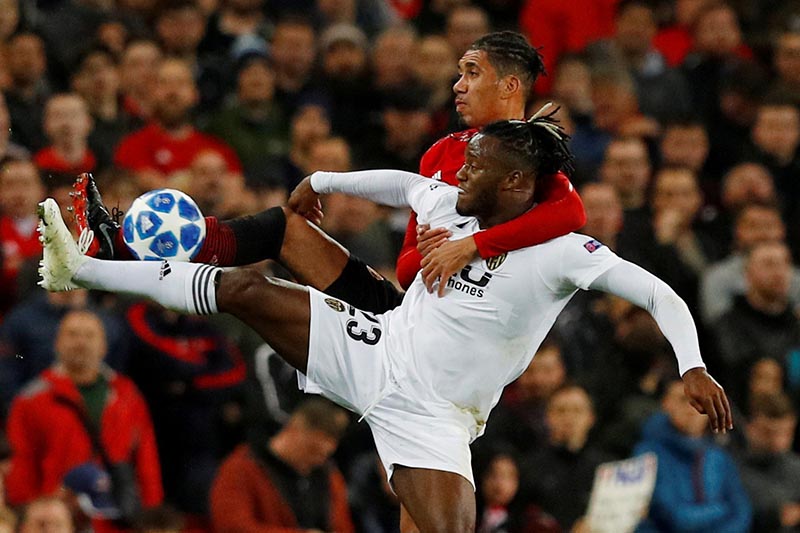 Manchester United's Chris Smalling in action with Valencia's Michy Batshuayi during the Champions League, Group H match between Manchester United and Valencia, at Old Trafford, in Manchester, Britain, on October 2, 2018. Photo: Reuters