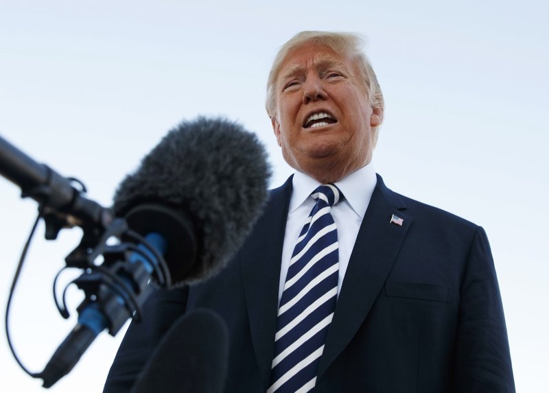 President Donald Trump speaks to media before boarding Air Force One at Elko Regional Airport, on Saturday, Oct. 20, 2018, in Elko, Nev., after a campaign rally. Photo: AP
