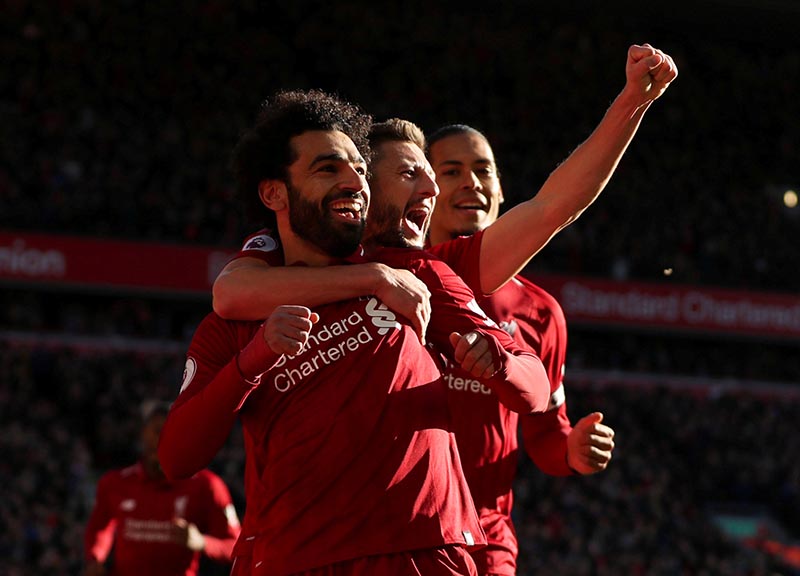 Liverpool's Mohamed Salah celebrates scoring their first goal with Adam Lallana and Virgil van Dijk during the Premier League match between Liverpool and Cardiff City, at Anfield, in Liverpool, Britain, on October 27, 2018. Photo: Action Images via Reuters