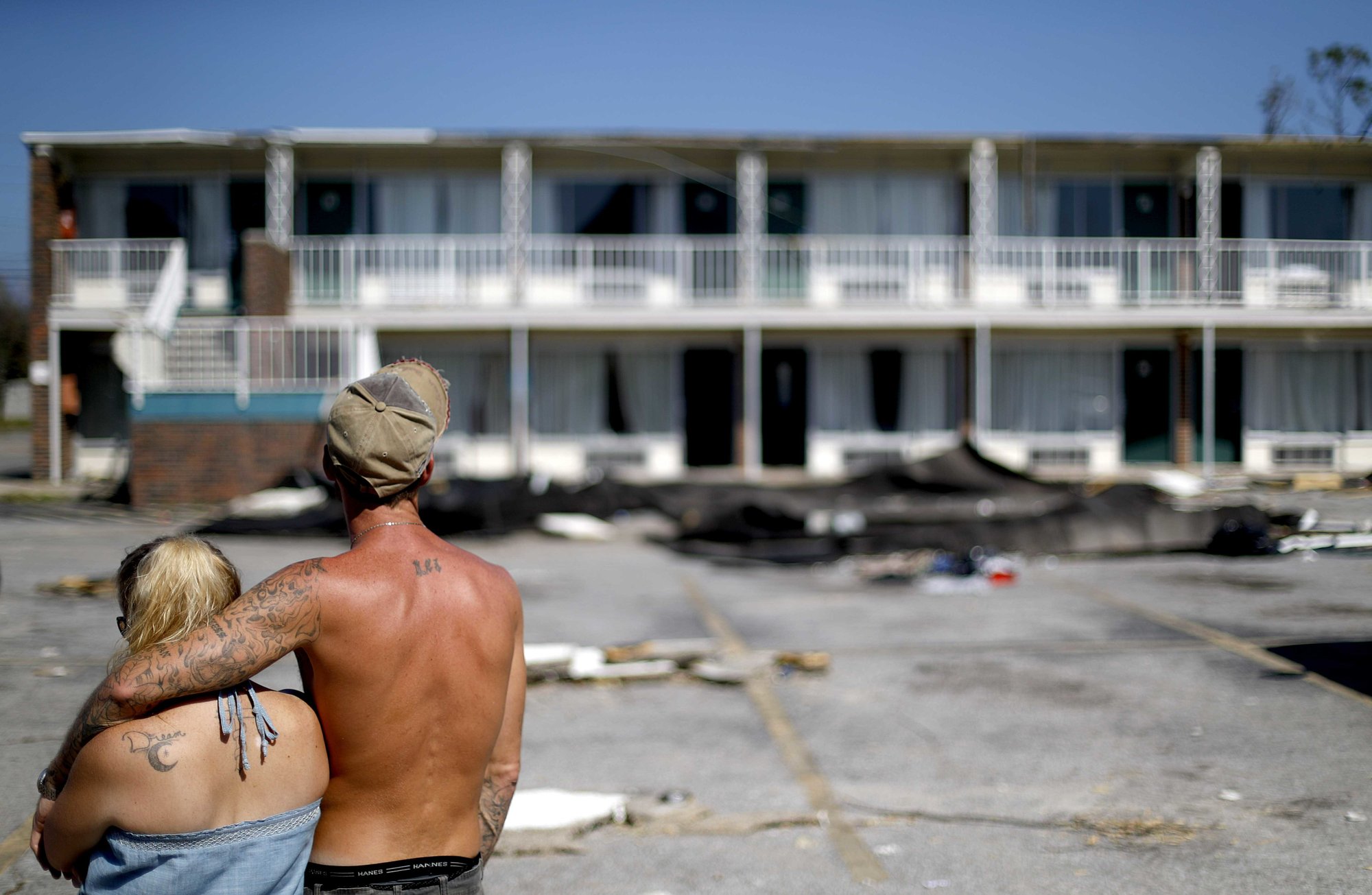 Residents line up for food from the Red Cross outside a damaged motel, Tuesday, Oct. 16, 2018, in Panama City, Fla., where many residents continue to live in the aftermath of Hurricane Michael. Photo: AP