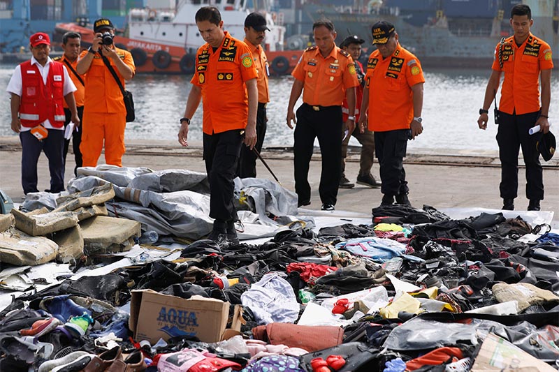 Chief of Indonesia's Lion Air flight JT610 search and rescue operations Muhammad Syaugi looks through recovered belongings believed to be from the crashed flight at Tanjung Priok port in Jakarta, Indonesia, on Tuesday, October 30, 2018. Photo: Reuters