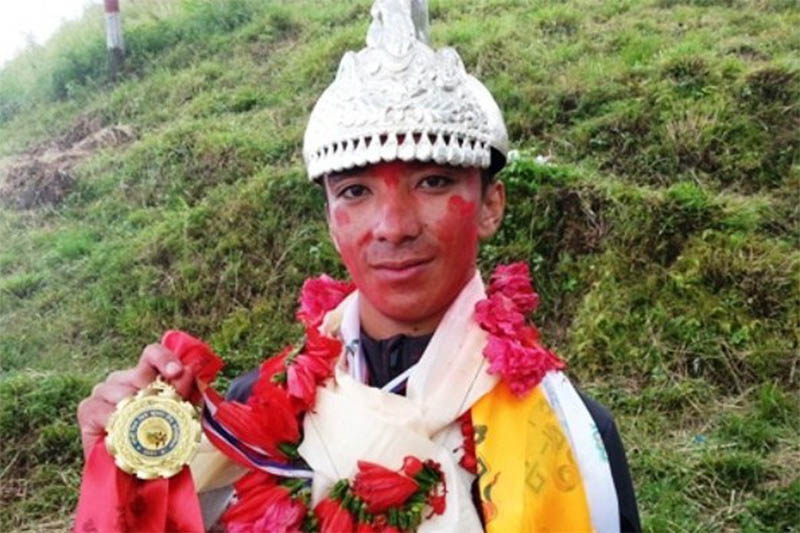 Anish Thapa shows his medal after winning this year's Ligelige raja title in Gorkha on Sunday, October 14, 2018. Photo: Ramji Rana