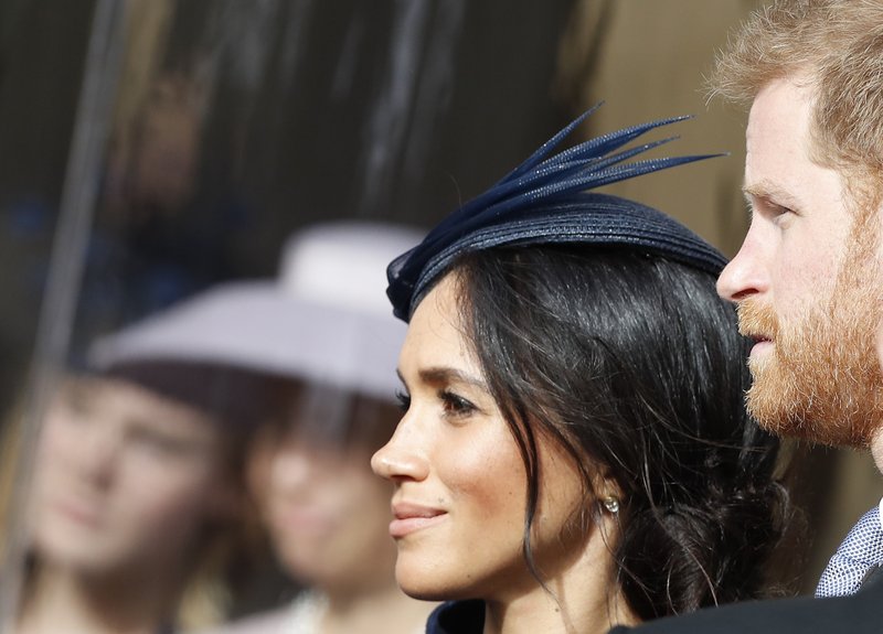 Prince Harry and his wife Meghan, Duchess of Sussex, smile as they wait for the bridal procession at the wedding of Princess Eugenie of York and Jack Brooksbank in St George's Chapel, Windsor Castle, near London, England, on Friday, Oct. 12, 2018. Photo: AP