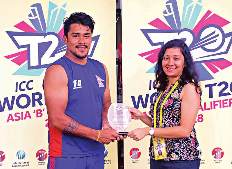 Nepal's Karan KC receives the man-of-the-match trophy after the ICC World Twenty20 Asia Region Qualifier 'B' match against Thailand in Kuala Lumpur on Sunday. Photo Courtesy: Raman Shiwakoti