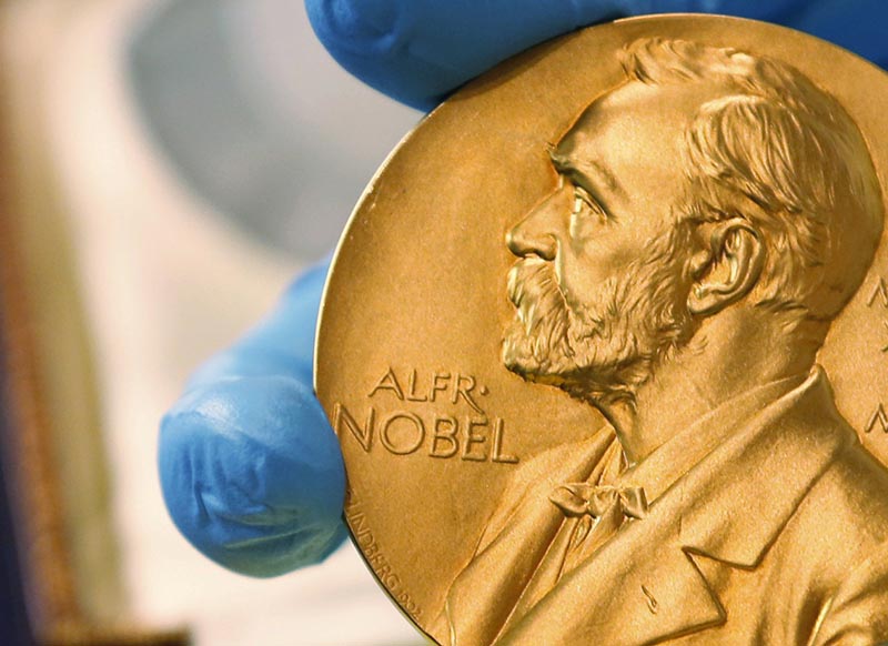 FILE- A national library employee shows the gold Nobel Prize medal awarded to the late novelist Gabriel Garcia Marquez, in Bogota, Colombia, on April 17, 2015. This yearu2019s round of Nobel Prizes begins Monday, Octoner 1, 2018, with the award for medicine or physiology, honoring research into the microscopic mechanisms of life and ways to fend off the invaders who cut it short. Photo: AP